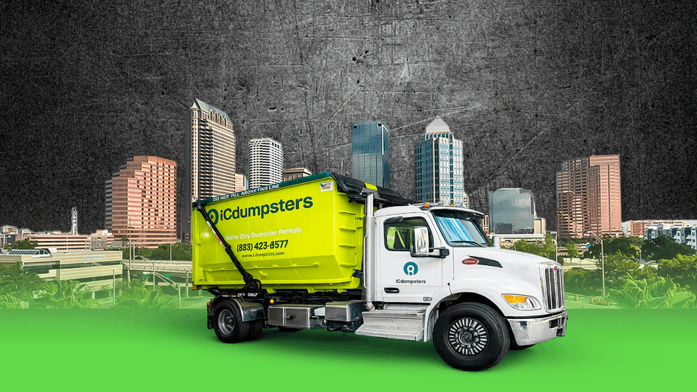 iCdumpsters delivery truck with roll-off dumpster against the Tampa skyline